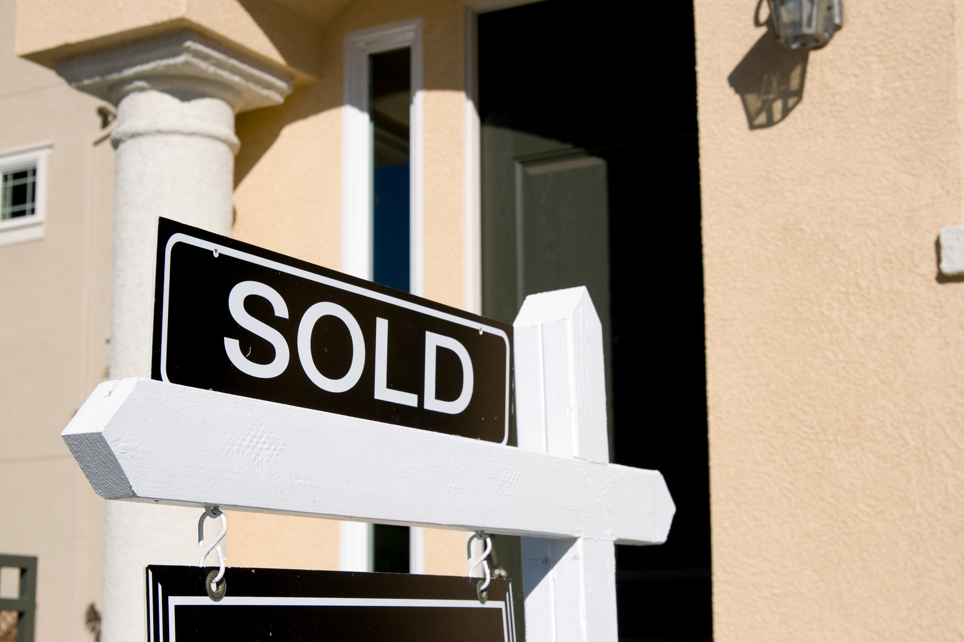 Real estate sign showing a sold house